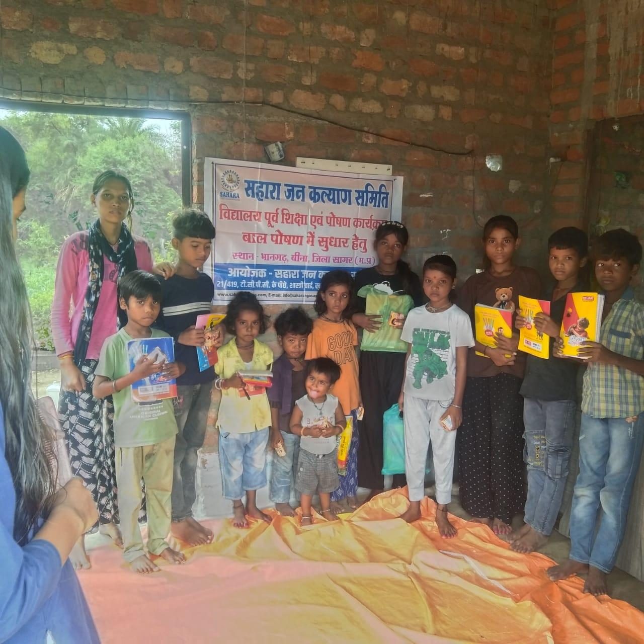 Children holding books after a learning session at a community centre