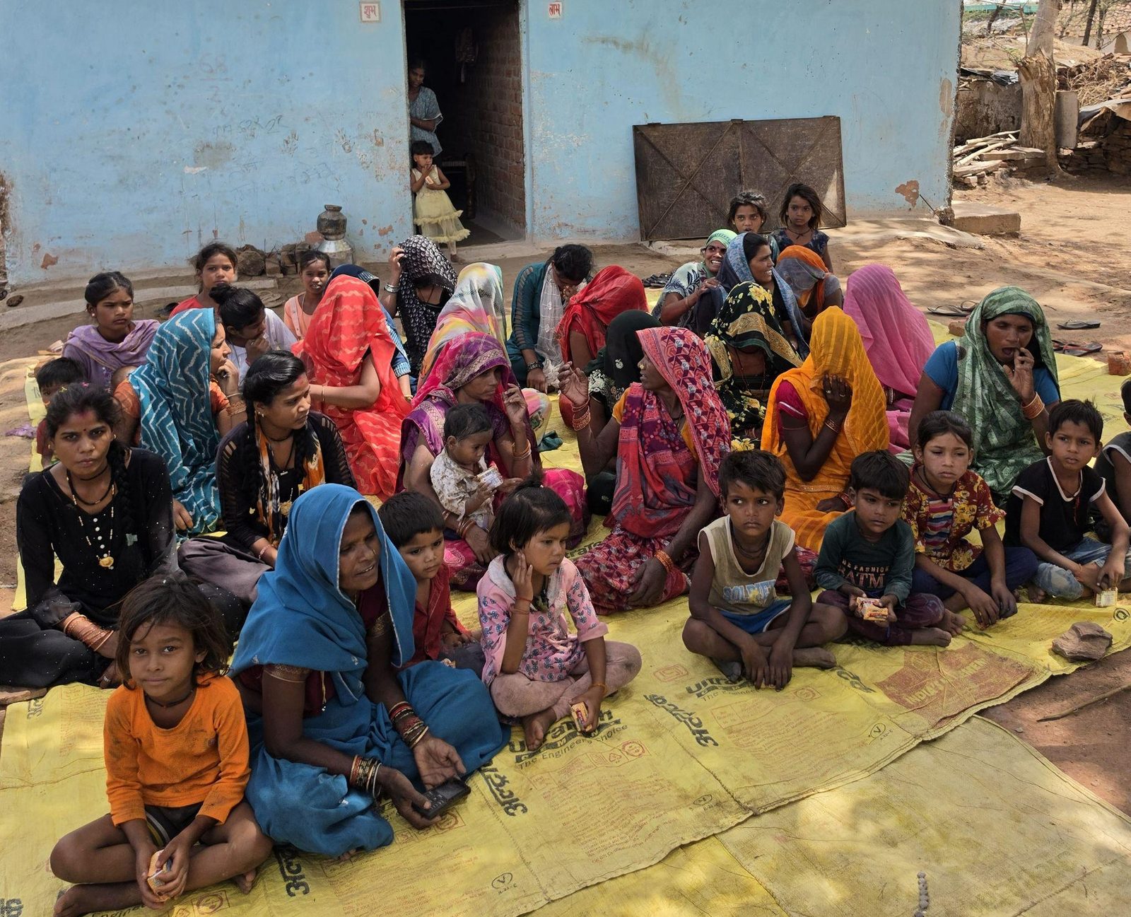 Women and children gathered for a community awareness session
