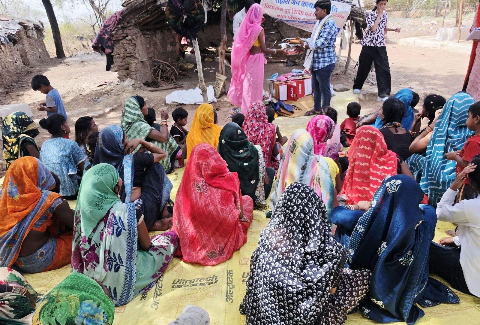 Families seated together at a community relief gathering